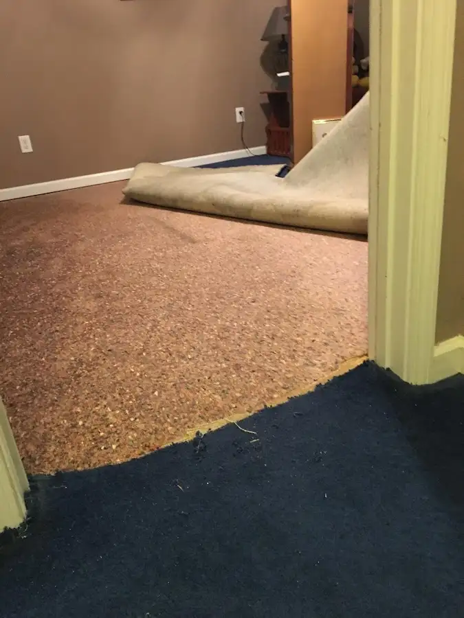 Carpet pad removal revealing water damage during Water Mitigation Services in Nassau Bay