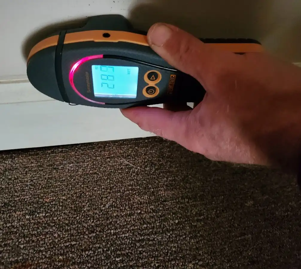Moisture detection at baseboard during Storm Damage Restoration in Nassau Bay